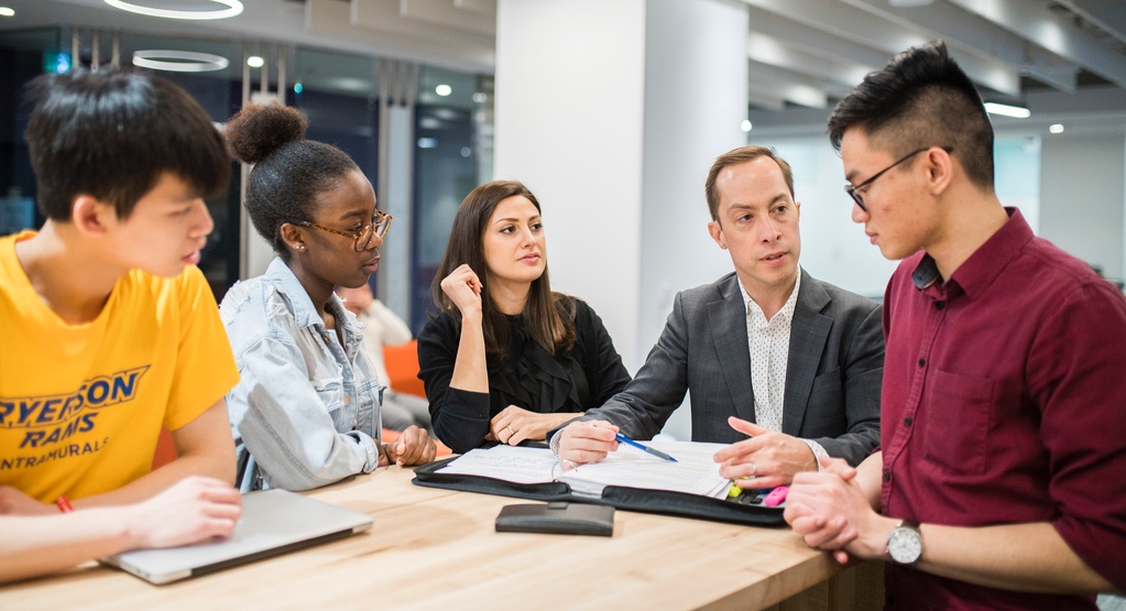 Image of students working with an instructor
